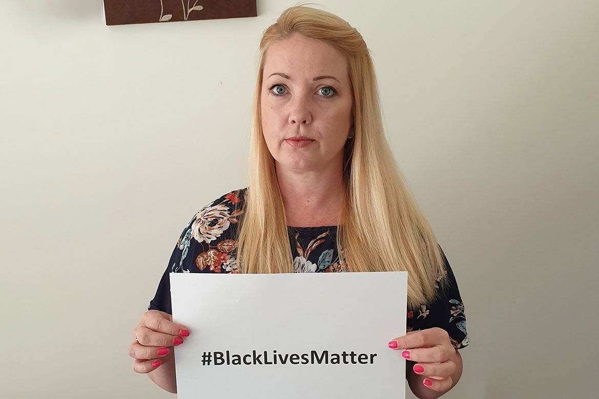 Kelly Parry holds Black Lives Matter sign