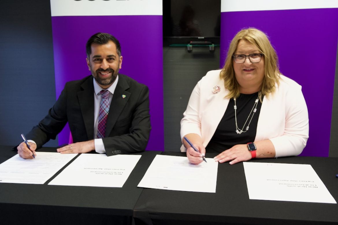 A man and a woman signing documents.